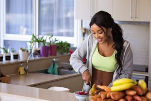 woman in kitchen eating healthy
